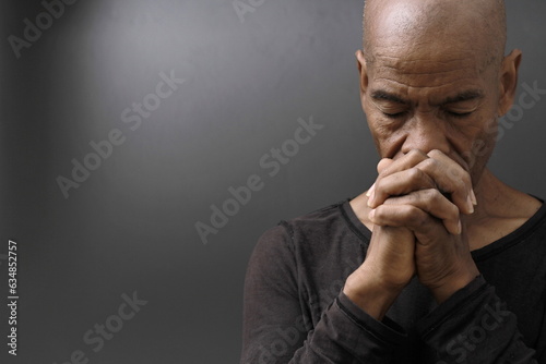 man praying to god with hands together on grey background with people stock image stock photo 