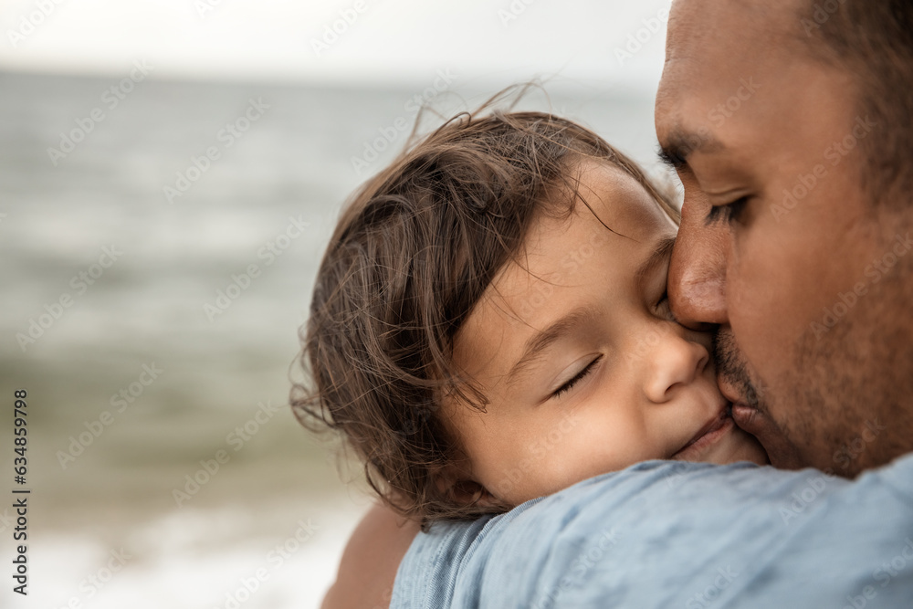 Closeup portrait of father kissing his little daughter, happy family and parenthood concept Closeup portrait of father kissing his little daughter, happy family and parenthood concept
