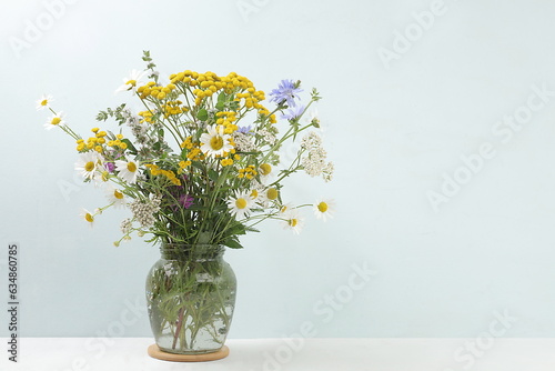 Fototapeta Naklejka Na Ścianę i Meble -  Flower arrangement of wild herbs and flowers , autumn background, tansy, mint, celandine, chamomile and yarrow in a jar , collection of useful herbs for treatment according to folk recipes.
