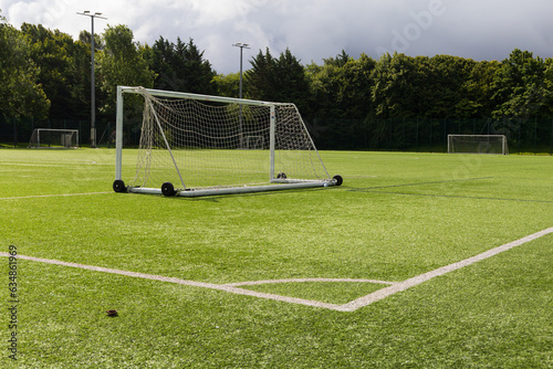A empty goal posts in a empty football pitch 