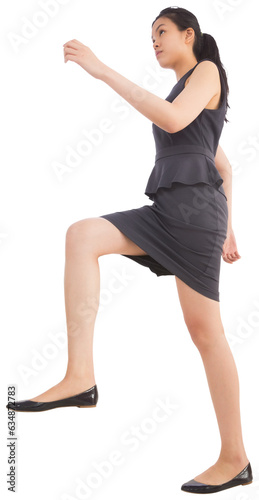 Digital png photo of serious asian businesswoman walking on transparent background