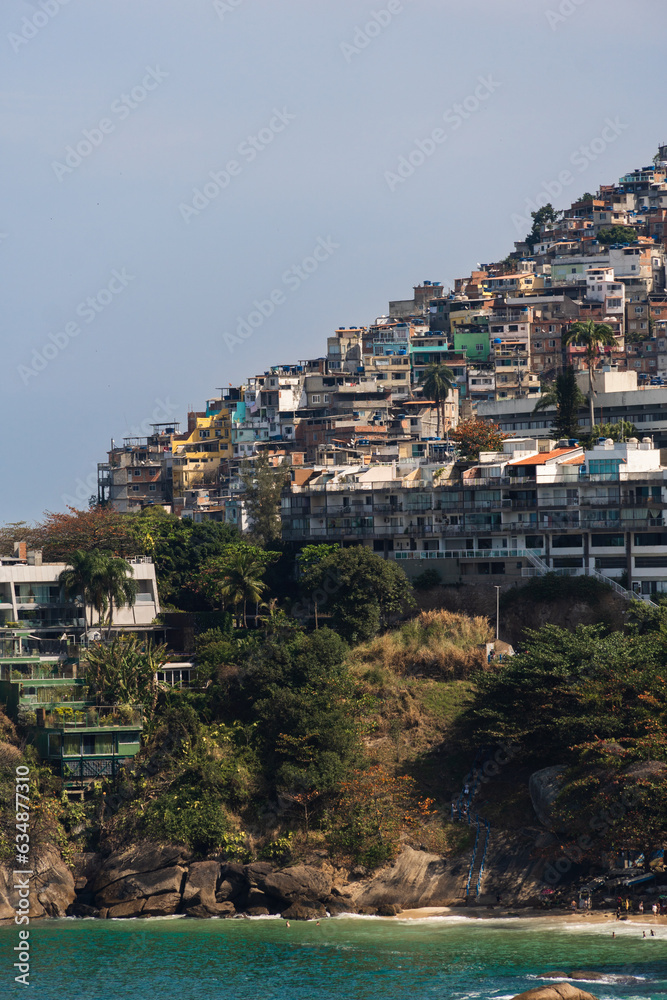 Vidigal beach and Morro do Vidigal in Rio de Janeiro, Brazil. Pacified community or favela. Slum. Sunny day with blue sky and some clouds. Turquoise and clear sea