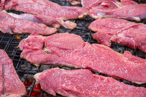 selective focus, raw beef fillets on a grill