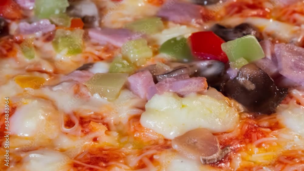 Zoom in shot: pizza with ham, mushroom, pepper, cheese baking on tray in electric oven at home - close up view, macro, timelapse. Italian cuisine, cooking and time lapse concept Zoom in shot: pizza with ham, mushroom, pepper, cheese baking on tray in electric oven at home - close up view, macro, timelapse. Italian cuisine, cooking and time lapse concept