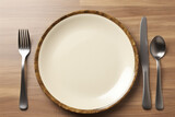 plate with fork, spoon  and knife on wooden table