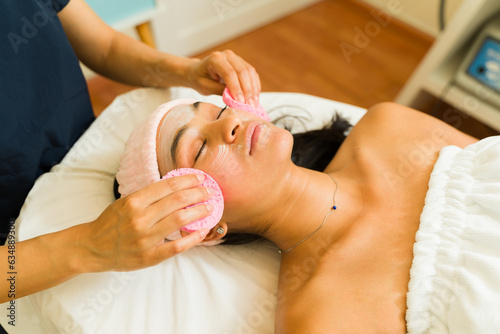 Young woman relaxing enjoying a facial treatment