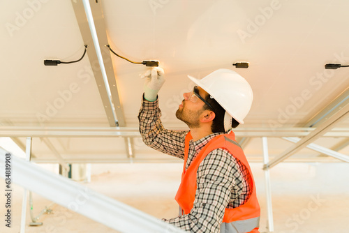 Solar panel installer working on the electrical connection photo