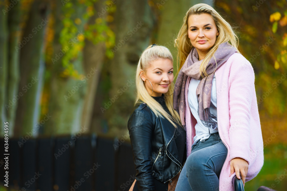 Naklejka premium Two women walking in autumn park