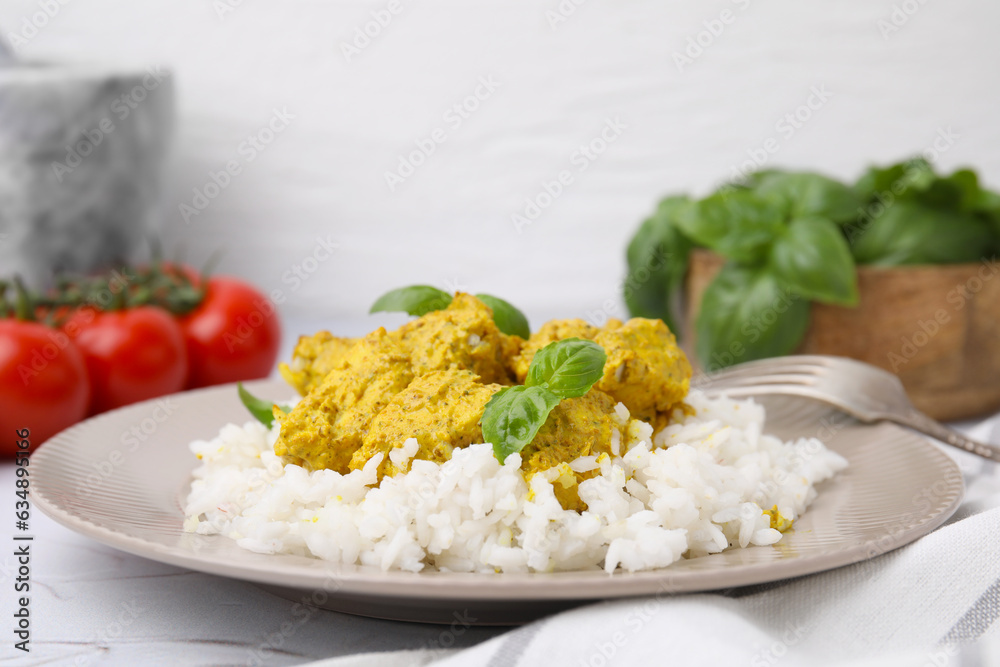 Delicious rice and chicken with curry sauce on white textured table, closeup Delicious rice and chicken with curry sauce on white textured table, closeup