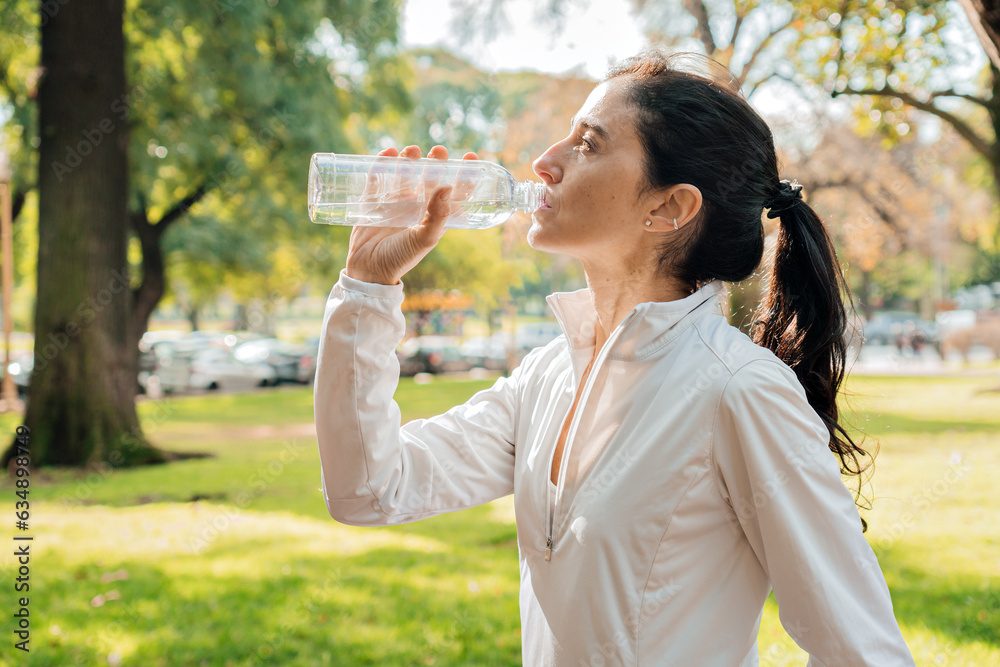 Middle-Aged Woman Drinking Water After Workout Middle-Aged Woman Drinking Water After Workout