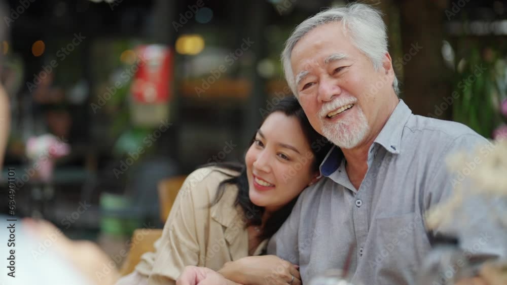 4K Happy Asian couple and elderly father having lunch eating meal together at cafe restaurant on summer holiday vacation. Family relationship, father's day and old senior people health care concept. 4K Happy Asian couple and elderly father having lunch eating meal together at cafe restaurant on summer holiday vacation. Family relationship, father's day and old senior people health care concept.