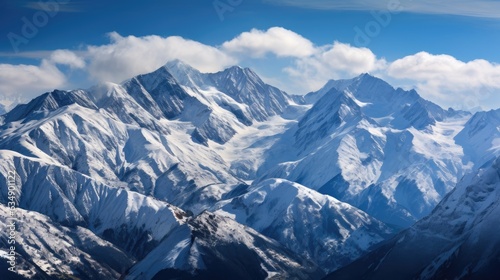 A striking view of snow-covered mountains, where the white peaks stand in stark contrast against the deep blue sky.