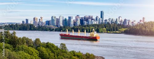 Cargo Ship arriving to the Port of Vancouver. Downtown City in background. Vancouver, BC, Canada