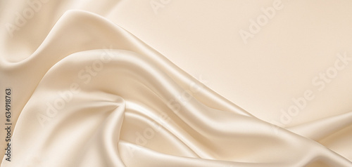 Soft pastel beige cream color, shiny satin silk swirl wave background banner - Abstract textile fabric material, backdrop texture for product display or text photo