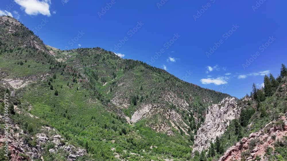 Aerial Mount Nebo Utah rocks peak up canyon. National Scenic Byway. Steep canyon valley, forest, waterfalls and snow banks. Nature and environment. Beautiful natural environment. Aerial Mount Nebo Utah rocks peak up canyon. National Scenic Byway. Steep canyon valley, forest, waterfalls and snow banks. Nature and environment. Beautiful natural environment.
