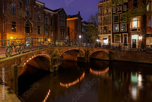 Foto View of the Amsterdam canals and embankments along them at night.