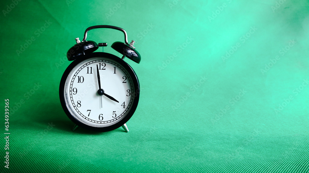4:00 o'clock, alarm clock isolated on green background 4:00 o'clock, alarm clock isolated on green background