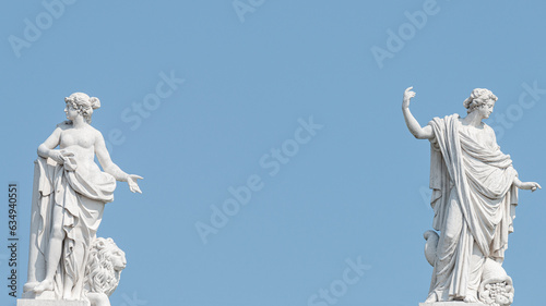 Potsdam, Germany -  Banner with old roof statues of  beautiful sensual Renaissance Era women with flowersand lion in Potsdam at blue sky solid background with copy space.