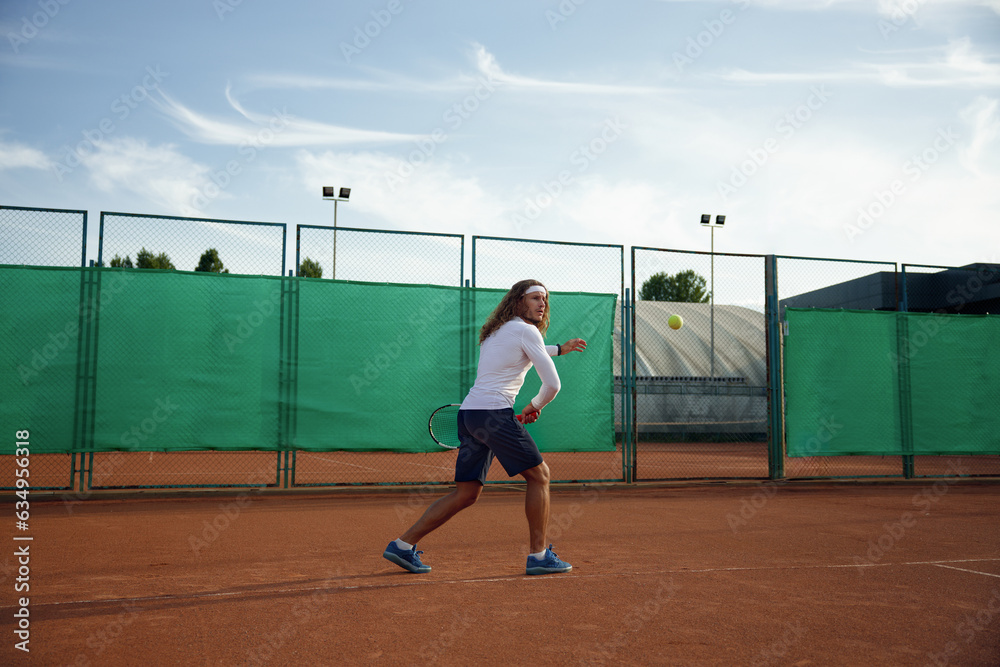 Young sports woman and man playing tennis on outdoor court