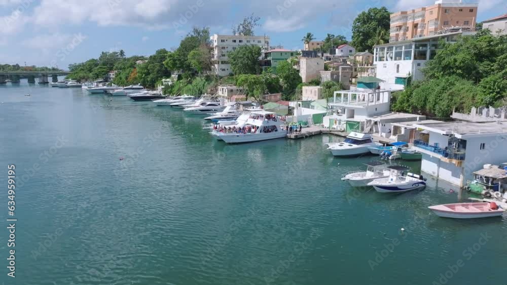 Flying over Rio Romana river water surface and yachts in Dominican Republic. Aerial drone view Flying over Rio Romana river water surface and yachts in Dominican Republic. Aerial drone view