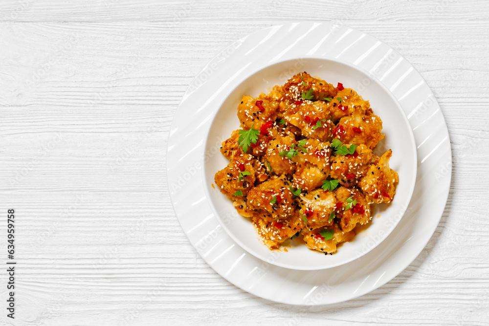 crispy orange cauliflower florets in white bowl crispy orange cauliflower florets in white bowl