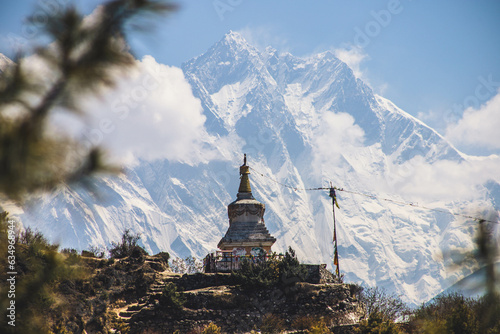 Famous Stupa in the trail to Everest Base camp with the amazing Ama Dablam Mountain in the background - Namche Bazar, Nepal photo
