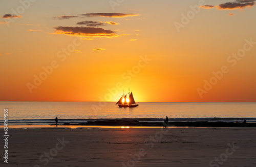 sailing ship over the sunset, Cable beach, Broome, Australia photo