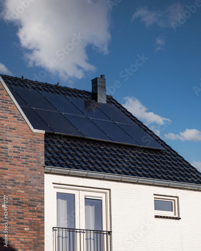 Newly build houses with solar panels attached on the roof , Solar panels producing clean energy on a roof of a residential house