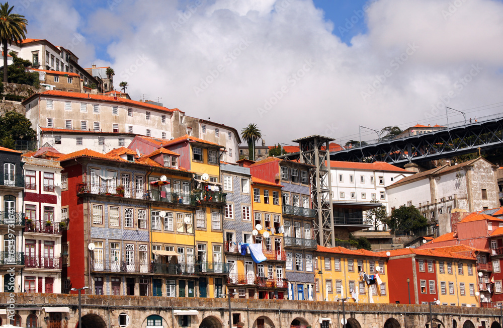 Embankment in Old Porto district, Porto, Portugal. Front view of historical center with colorful medieval houses of Oporto city, Ribeira. View from Douro river