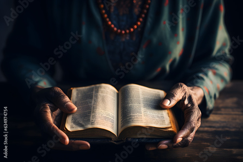 Fototapet Hands hold an open Bible, capturing a moment of reverence and connection to sacred teachings