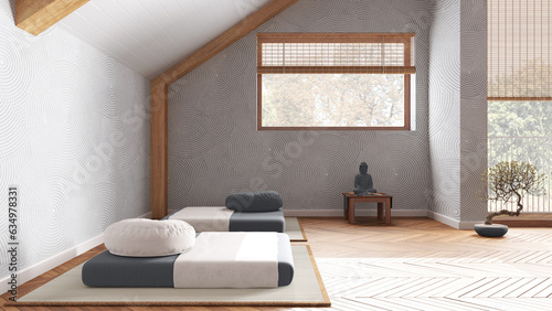 Minimal meditation room in white and gray tones in attic apartment. Tatami mats, pillows and table with decors. Wooden beams and window. Japandi interior design photo