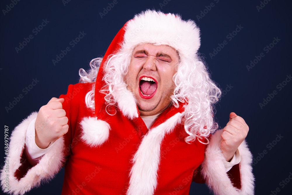 Christmas and New Year. Funny Drag Queen dressed as Santa Coat posing with different emotions on a blue background. Christmas and New Year. Funny Drag Queen dressed as Santa Coat posing with different emotions on a blue background.