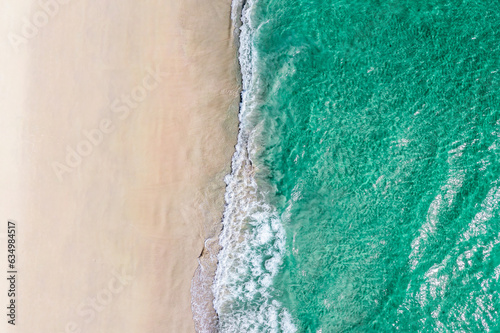 Summer seascape beautiful waves, blue sea water in sunny day. Aerial drone view, amazing tropical nature background.
