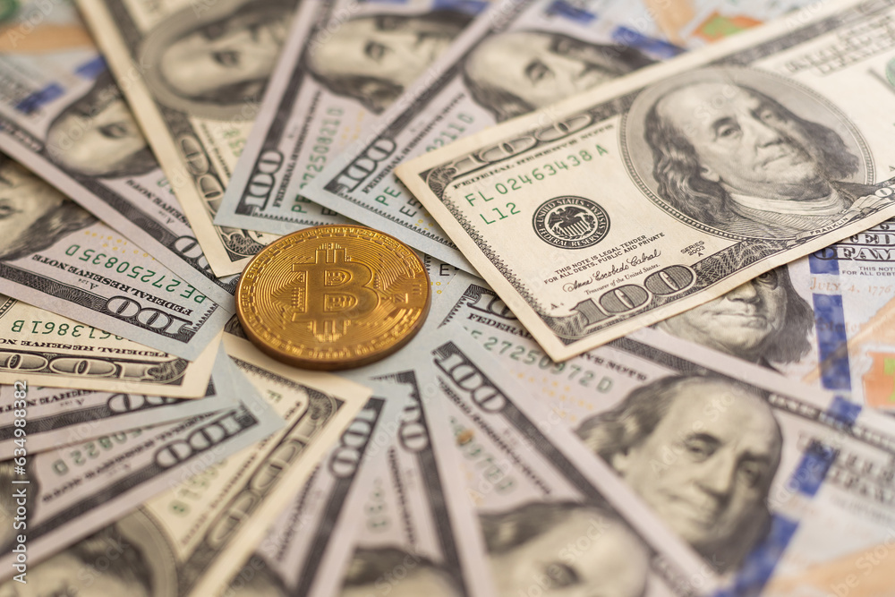 Golden bitcoin on USD 100 billnote dollar background. Finance concept.