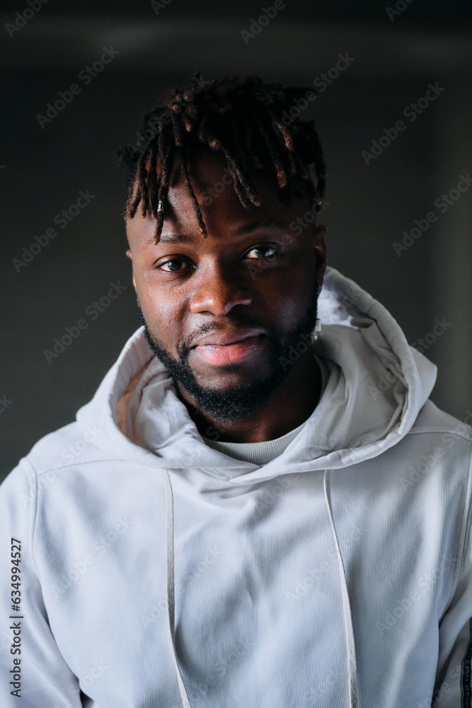 Smiling cheerful man in hoodie looking at camera Smiling cheerful man in hoodie looking at camera
