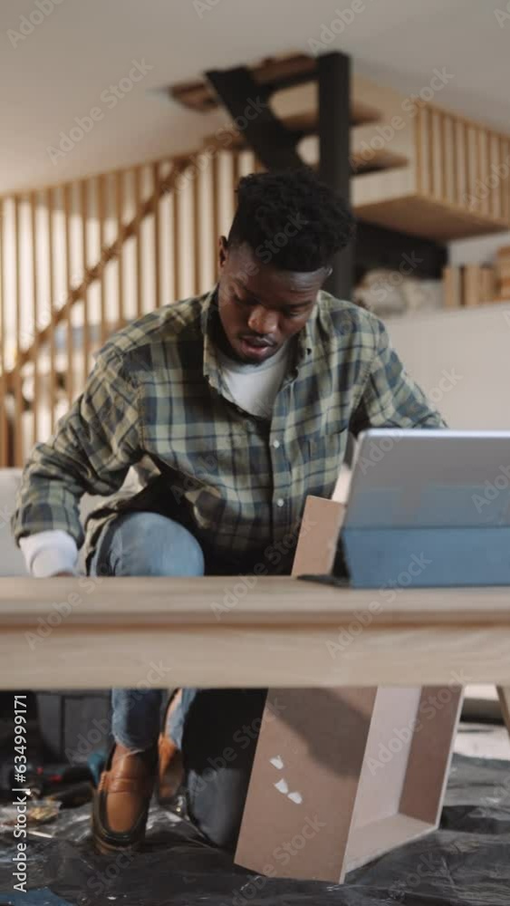 A Black Man Filming a DIY Project in His Lounge A Black Man Filming a DIY Project in His Lounge