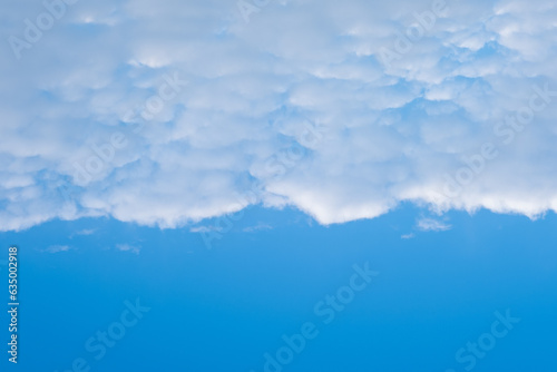 Dense white horizontal clouds in half the frame and blue sky. A heavenly background to overlay on your photos.