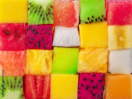 Fruit puzzle. Colorful food background or pattern arranged of different fruit cubes. Dietary concept.