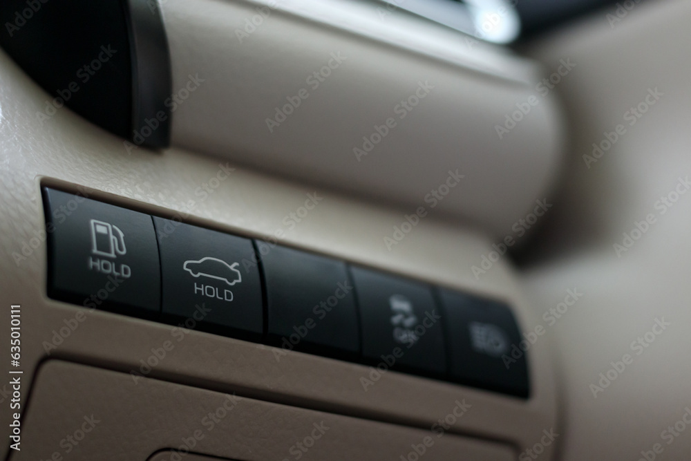 car trunk opening button on dashboard, car boot release switch, push and hold to open trunk, selective focus car trunk opening button on dashboard, car boot release switch, push and hold to open trunk, selective focus