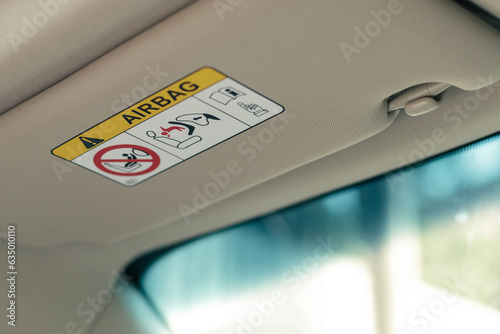 airbag warning label on sun visor, signs of airbag system photo