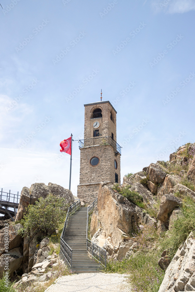 Gonul Mountain in Eskişehir Sivrihisar Old stone clock tower and Turkish flag among blue sky and stones. Gonul Dagi Sivrihisar Gonul Mountain in Eskişehir Sivrihisar Old stone clock tower and Turkish flag among blue sky and stones. Gonul Dagi Sivrihisar