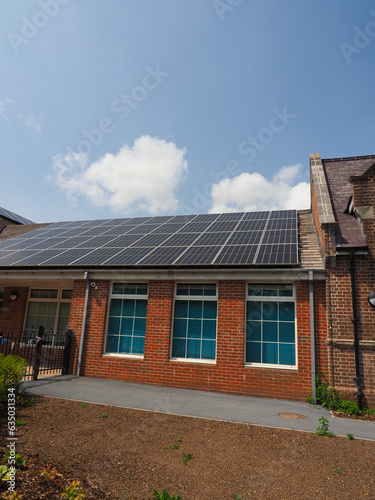 Newly fitted solar panels on the roof of an old school building