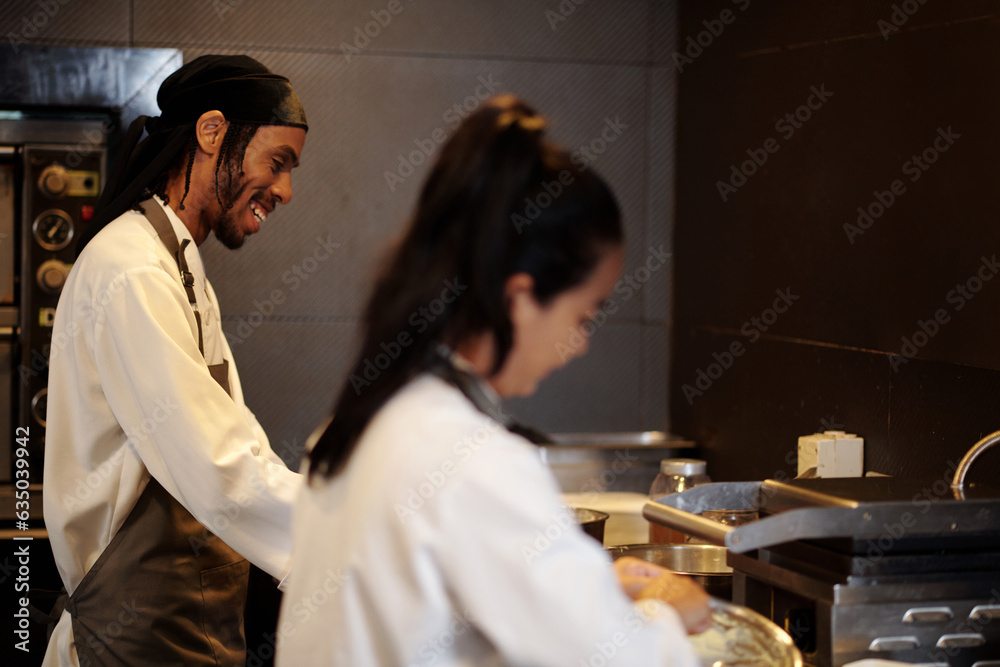 Jouful cook enjoying his first day at work in new restaurant Jouful cook enjoying his first day at work in new restaurant
