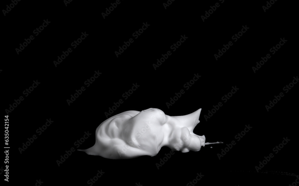 Naklejka premium liquid white foam from soap or shampoo or shower gel Abstract soap bubbles. Set foam, soap bubble isolated on black, with clipping path texture and background.