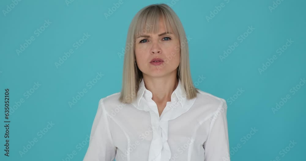 Shocked woman is shown covering her mouth in surprise on a serene blue background. Her wide-eyed expression and the gesture of covering her lips indicate her astonishment.