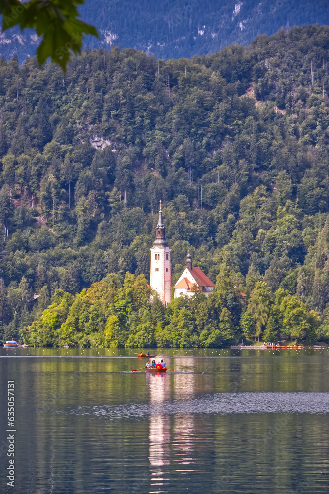 Fototapeta premium Church of the Assumption of Mary in the center of the lake Bled. Small island on Bled Lake in Slovenia, vertical view.