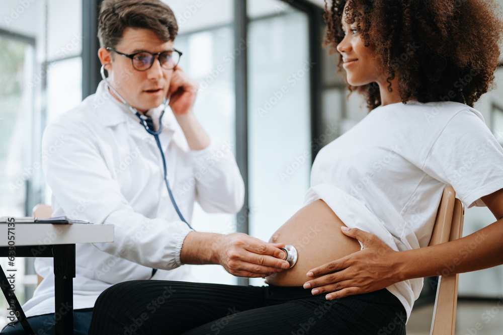 Pregnant african woman has appointment with doctor at clinic. Male ...