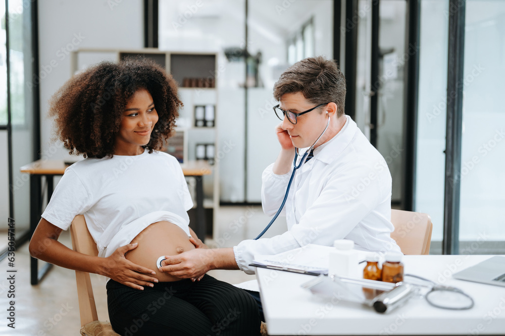 Pregnant african woman has appointment with doctor at clinic. Male ...