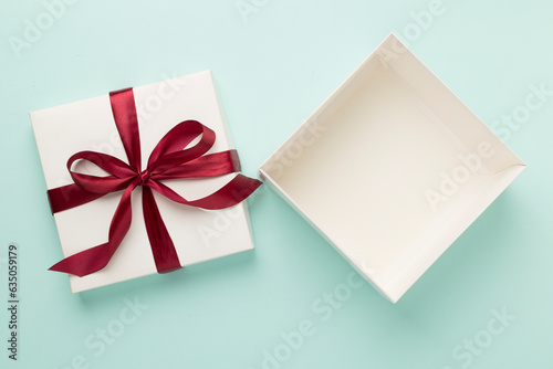 Open gift box on color background, top view. Mock up for design
