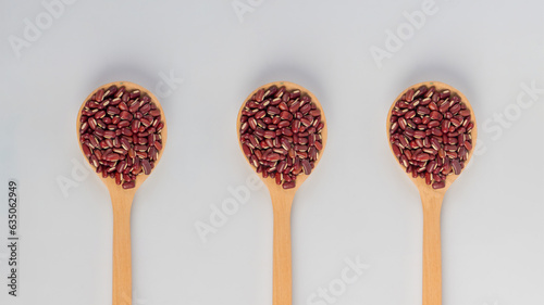 Red kidney beans on spoon wooden on white background